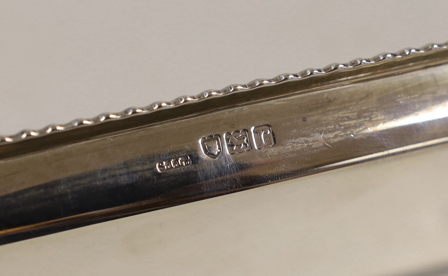 A George V engraved silver card case, by Crisford & Norris, a silver pen tray and four manicure tools.